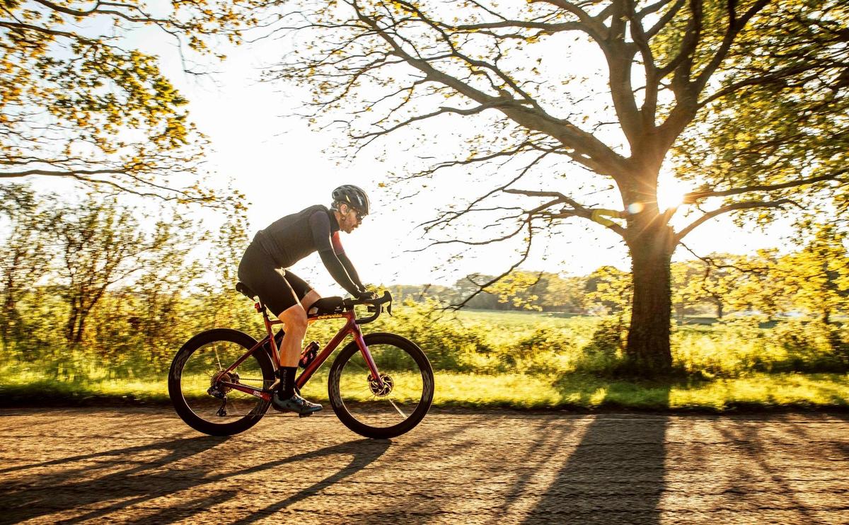 Chris Hall cycling through woods