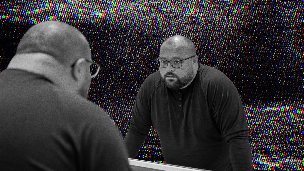 A man looking at himself in the mirror.