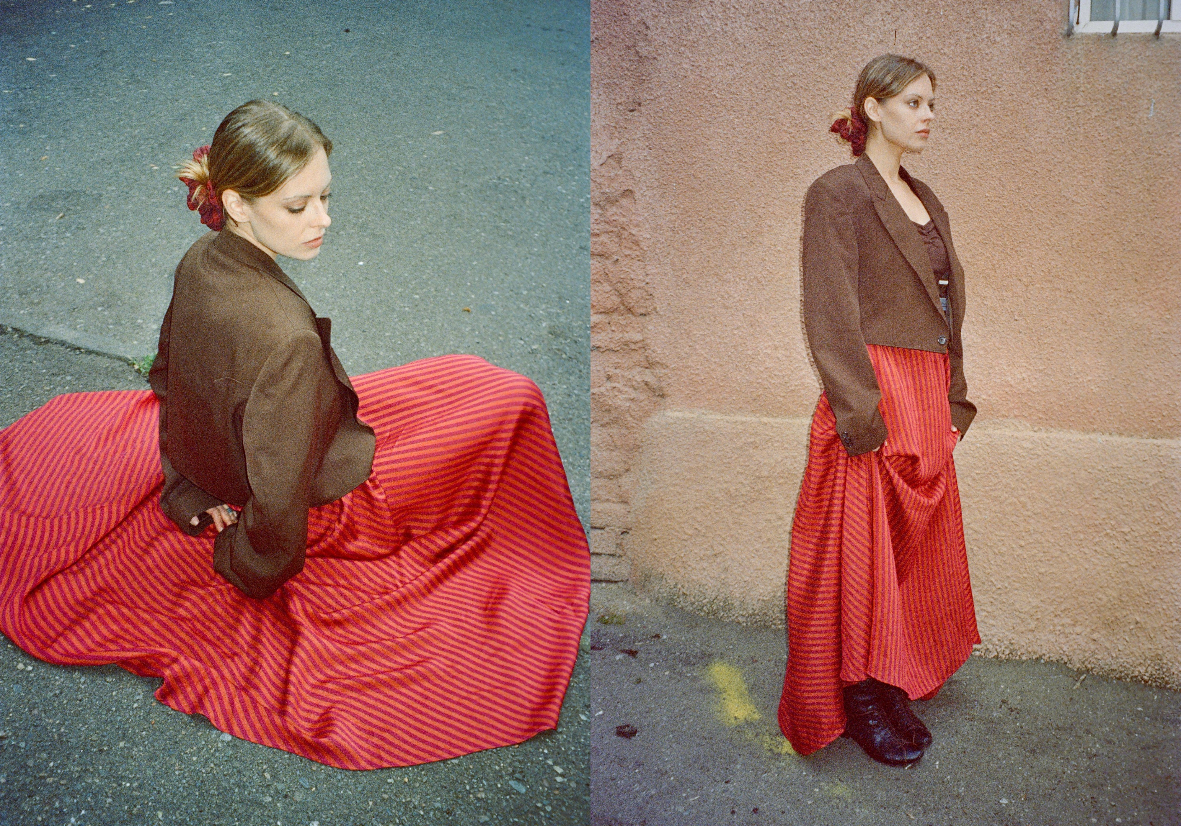 model wearing white shirt with striped scarf, and a striped skirt