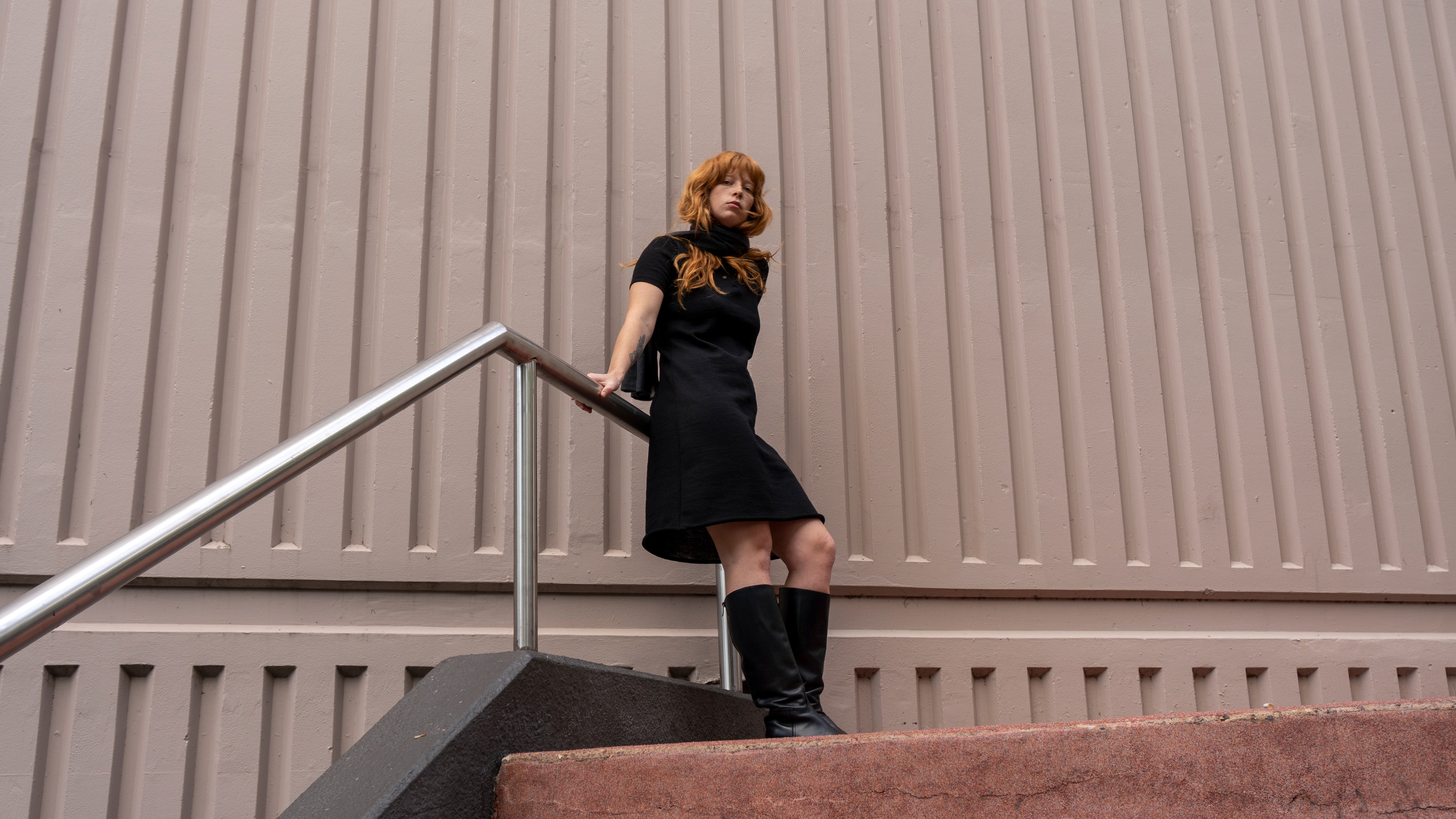 Model wearing a Celia dress and black boots