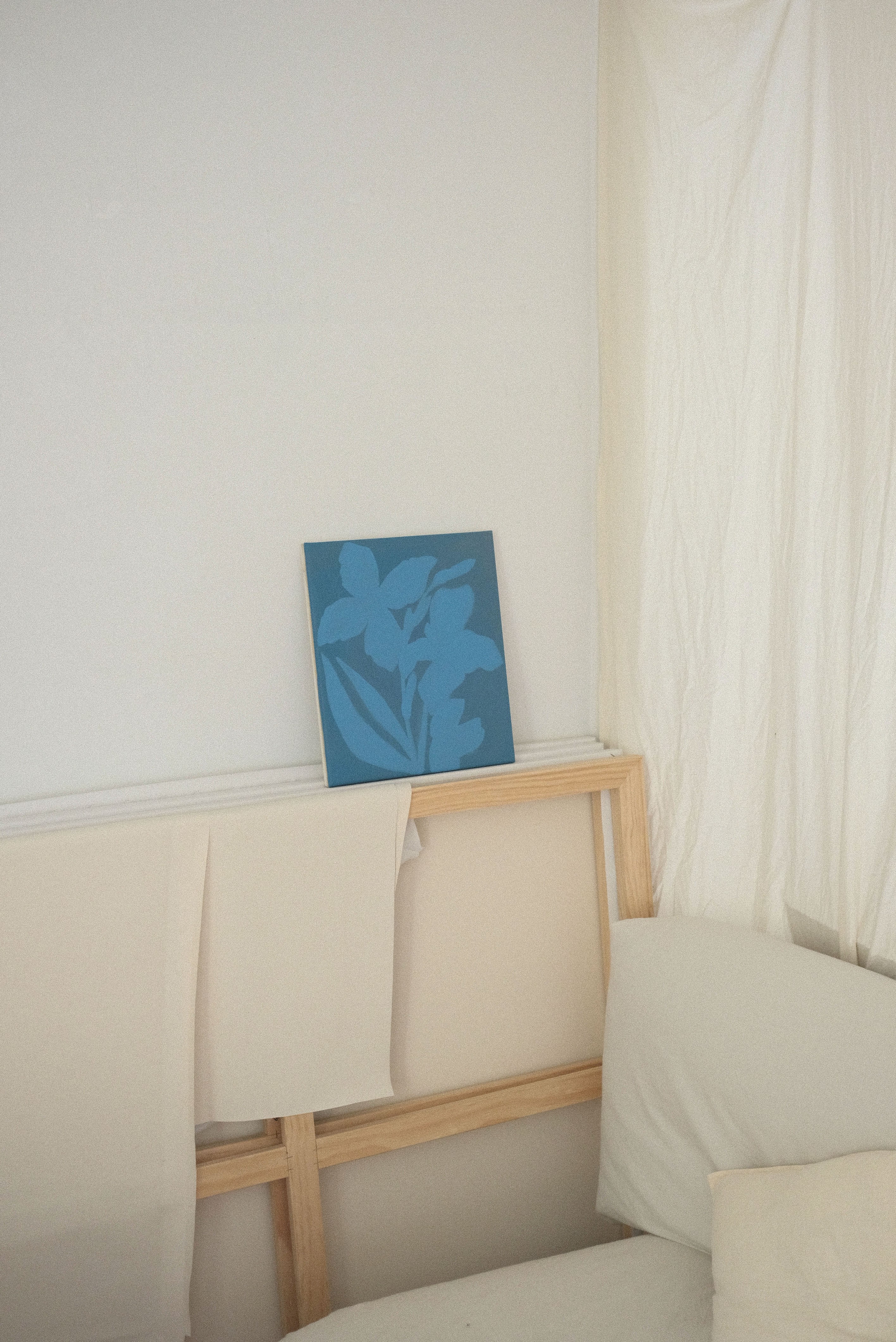 Briana Jamieson painting of blue Iris' resting on a large canvas in a painting studio