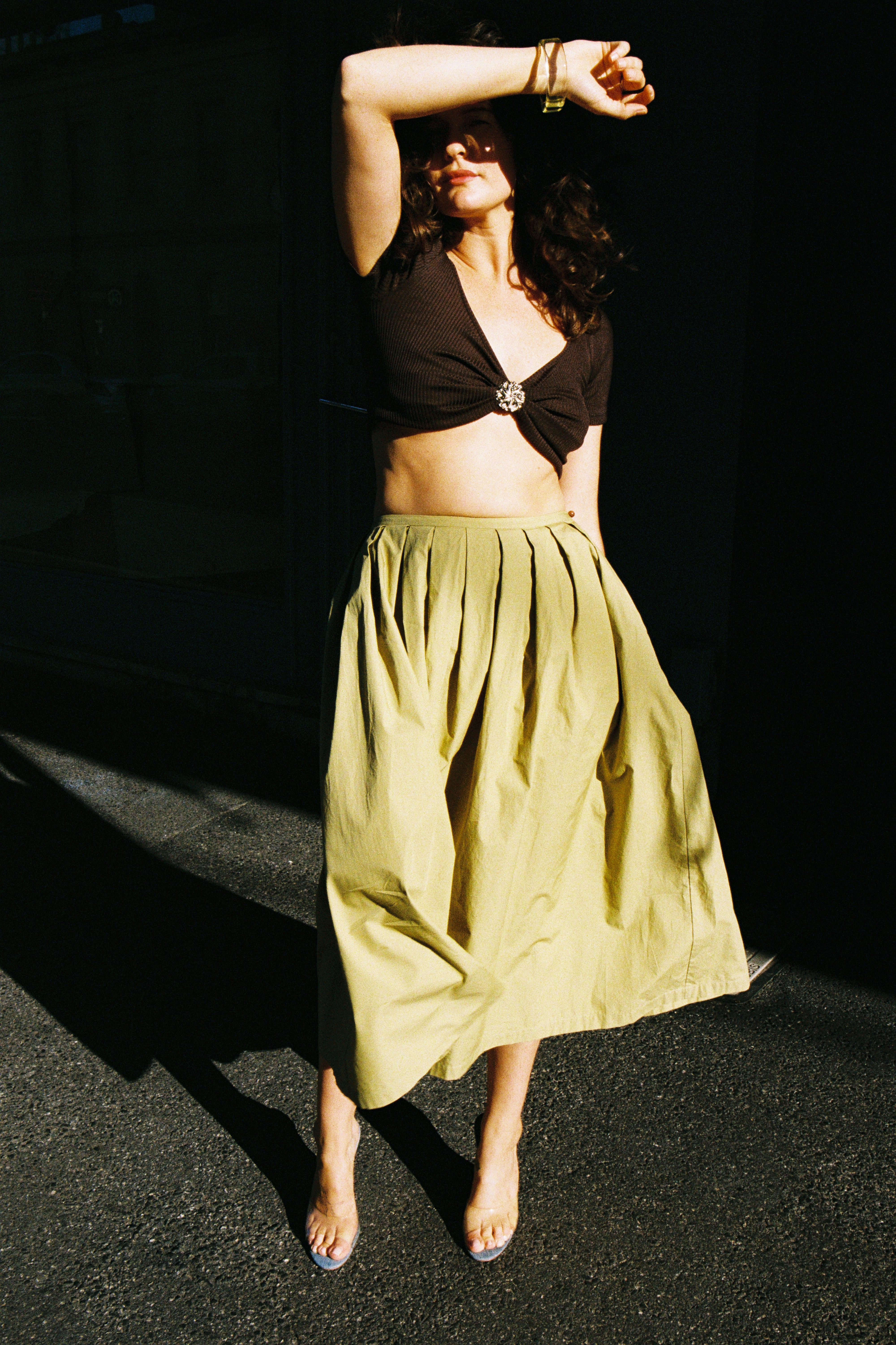 Model wearing fennel pleated skirt and cocoa silk rib top