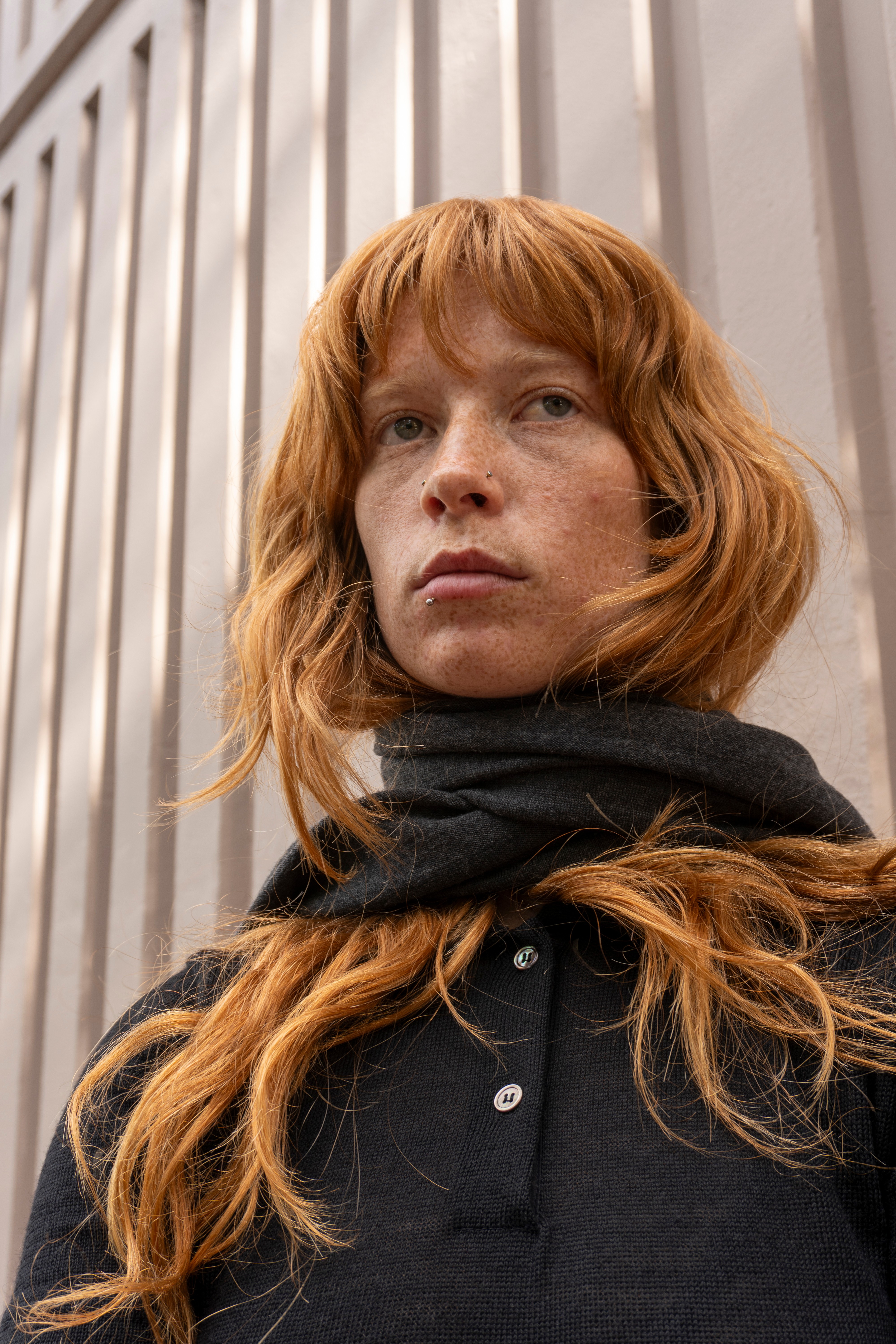 Model wearing a Raisin Melange Serafina top and swishing their hair 