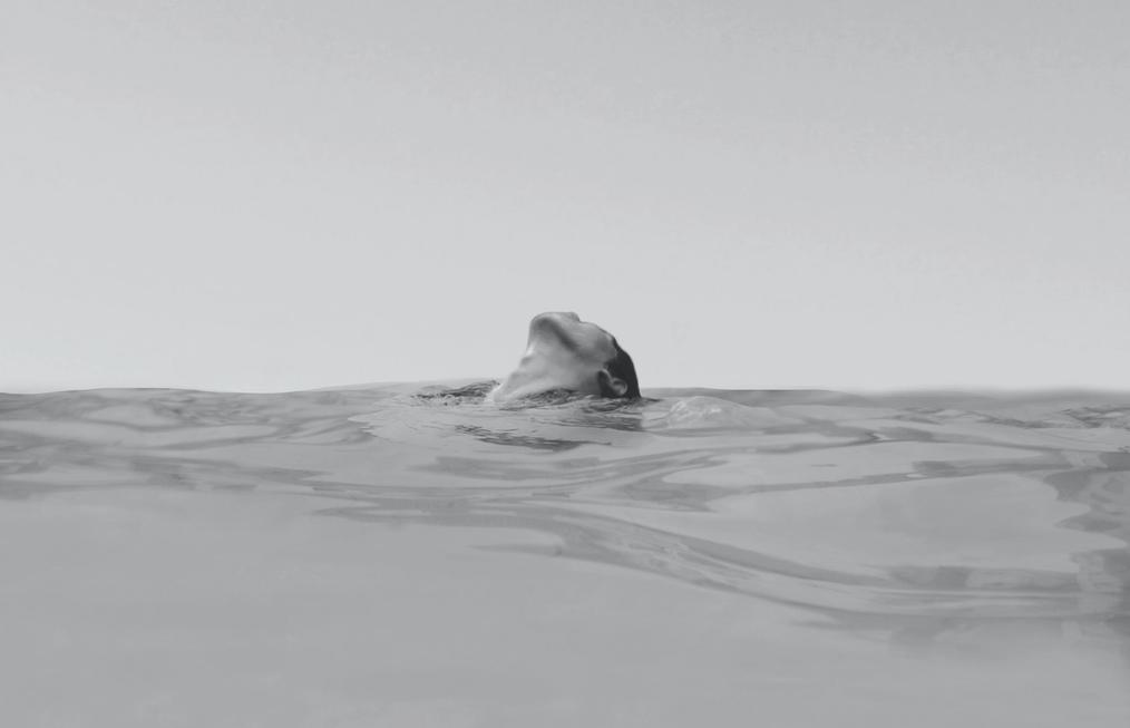 Grayscale photo of a woman floating in water.