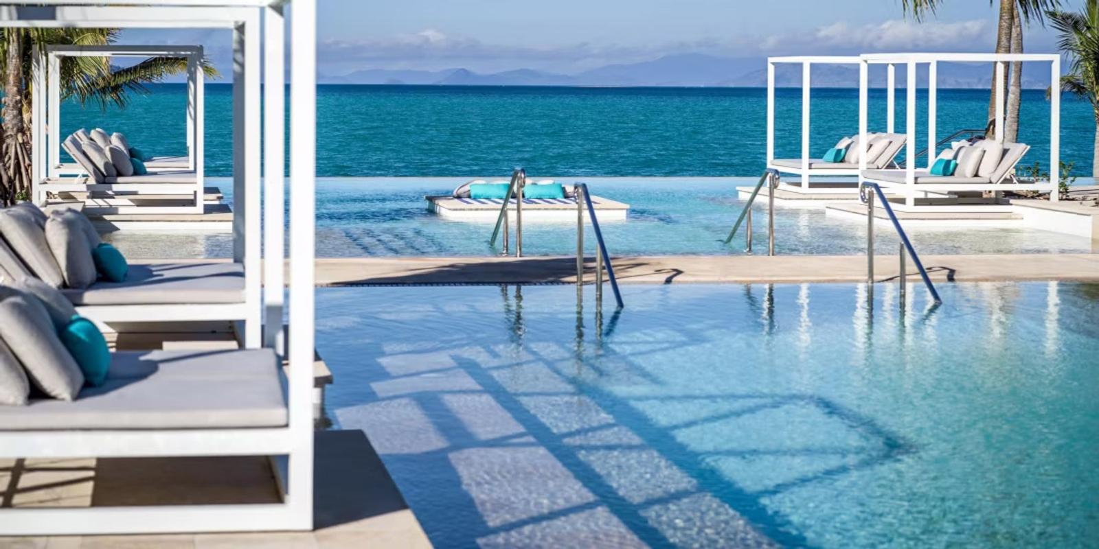 Infinity pool daybeds facing the Whitsunday Passage