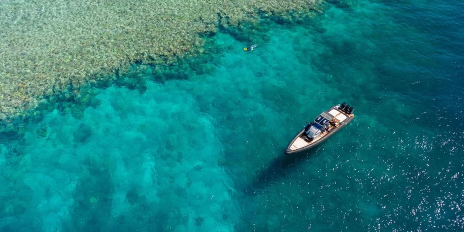 A tender over the coral, at the reef edge