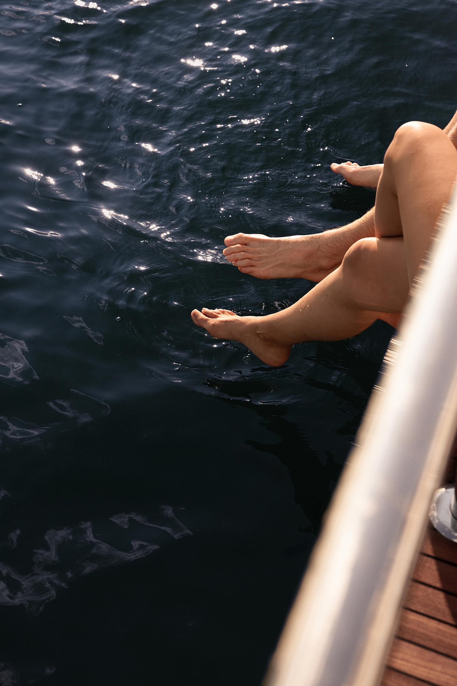 Feet in the water from the swim platform on a calm day