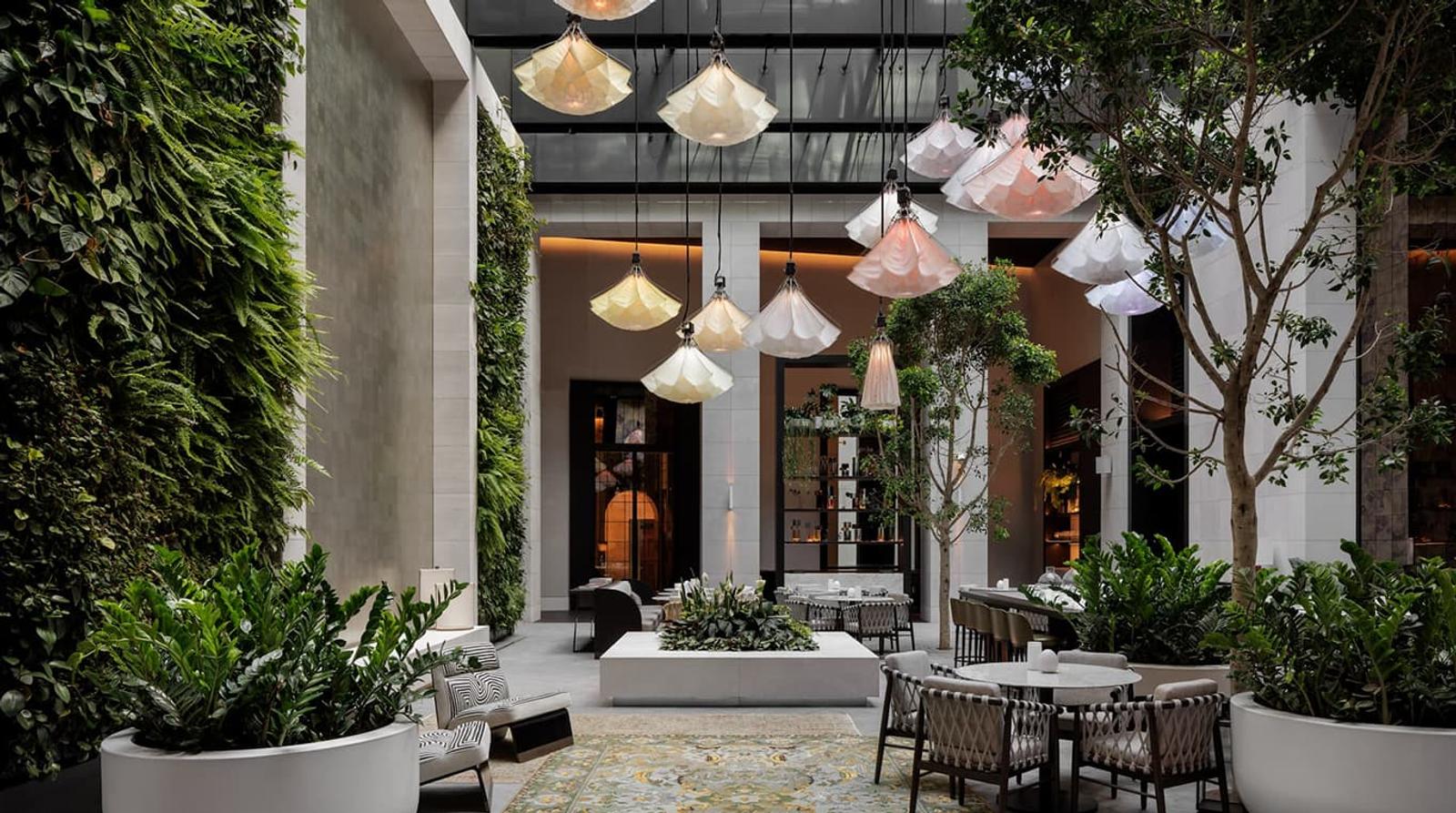 Aperture — the garden atrium under its lantern pendants