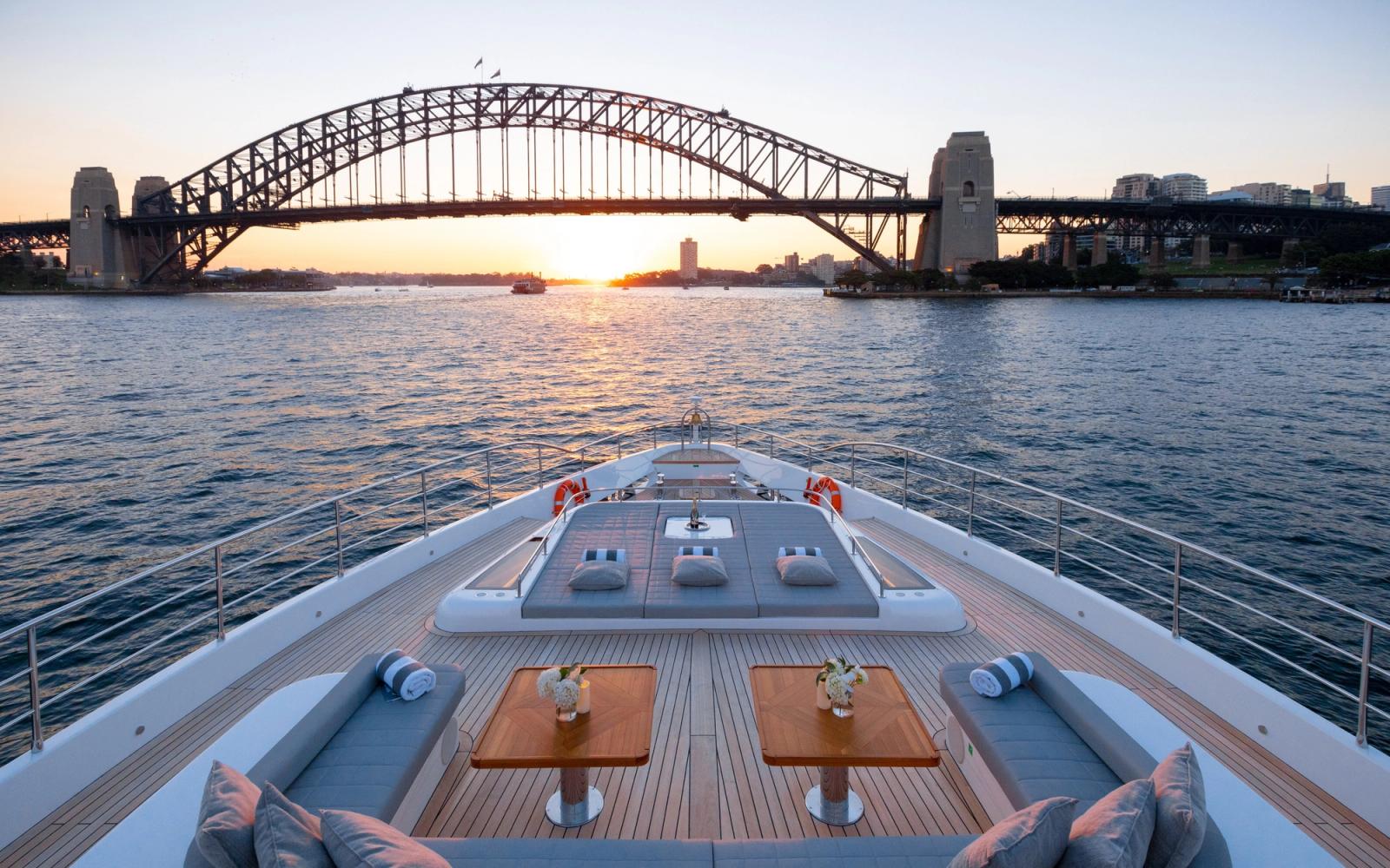 ONEWORLD — bow toward the Harbour Bridge at dusk
