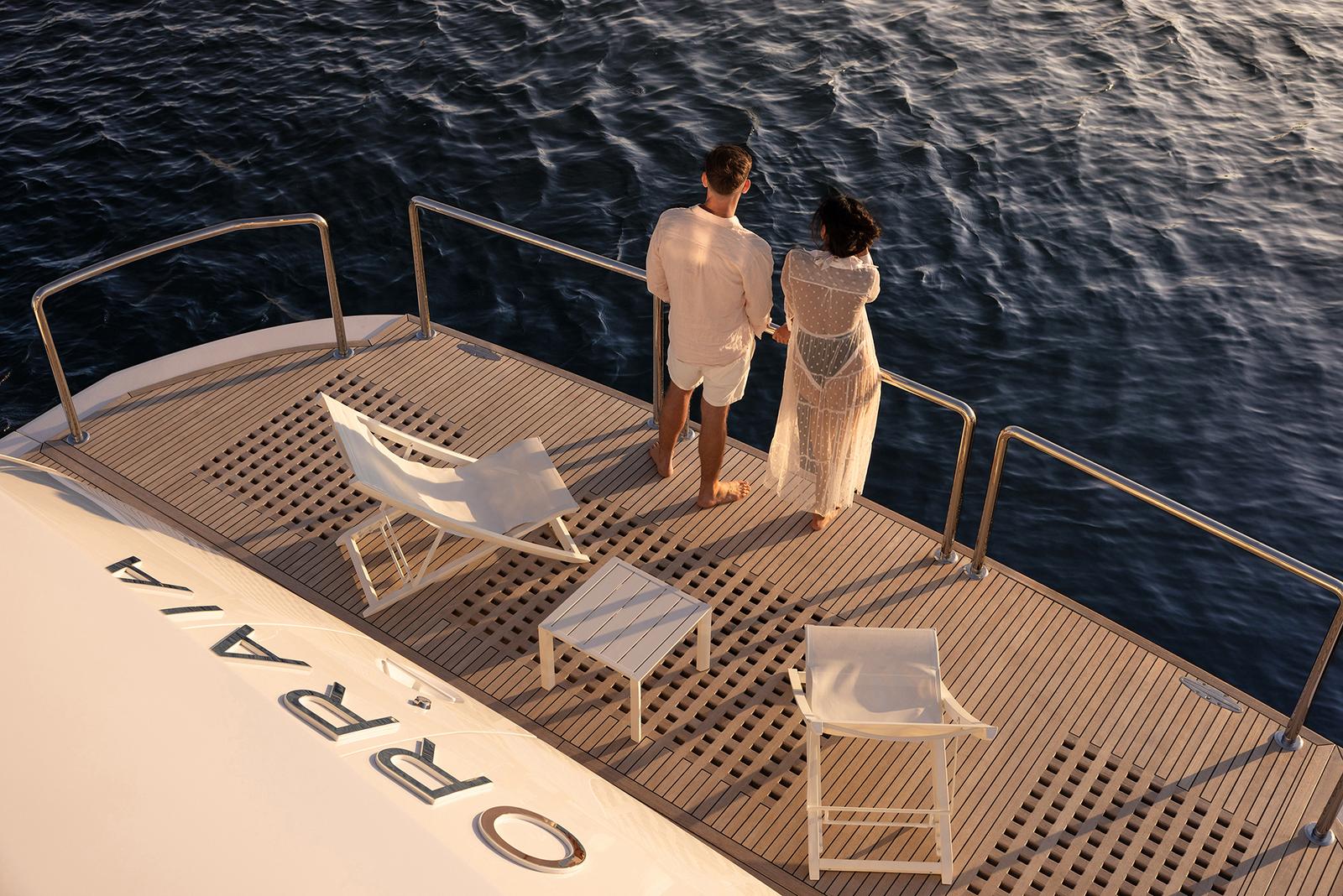 A couple aboard ORRAIA at golden hour