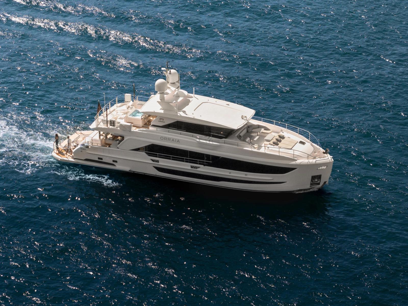 Aerial view of a superyacht underway across open blue water off Fiji