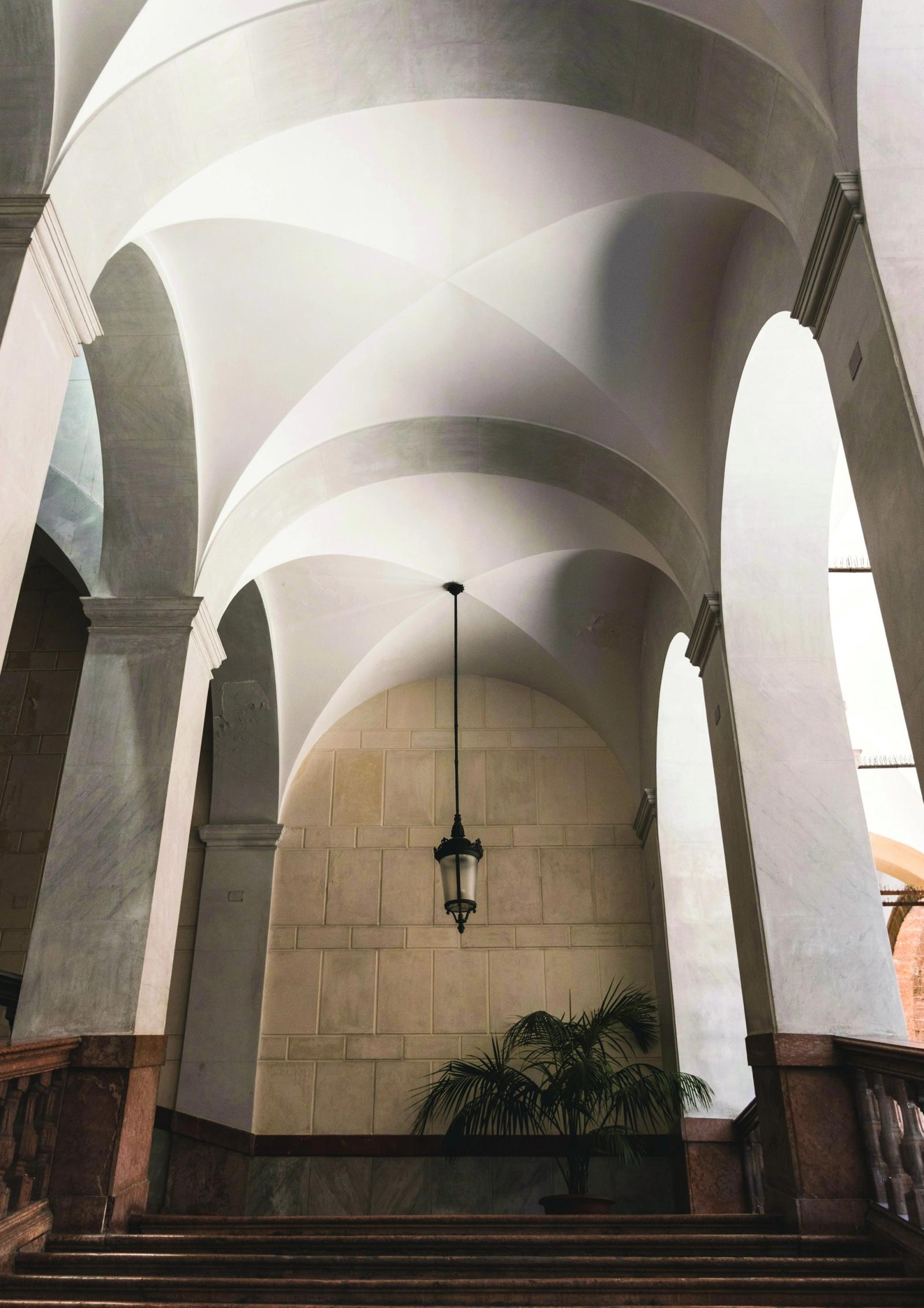 Sunlit vaulted stone arches of a grand colonnade