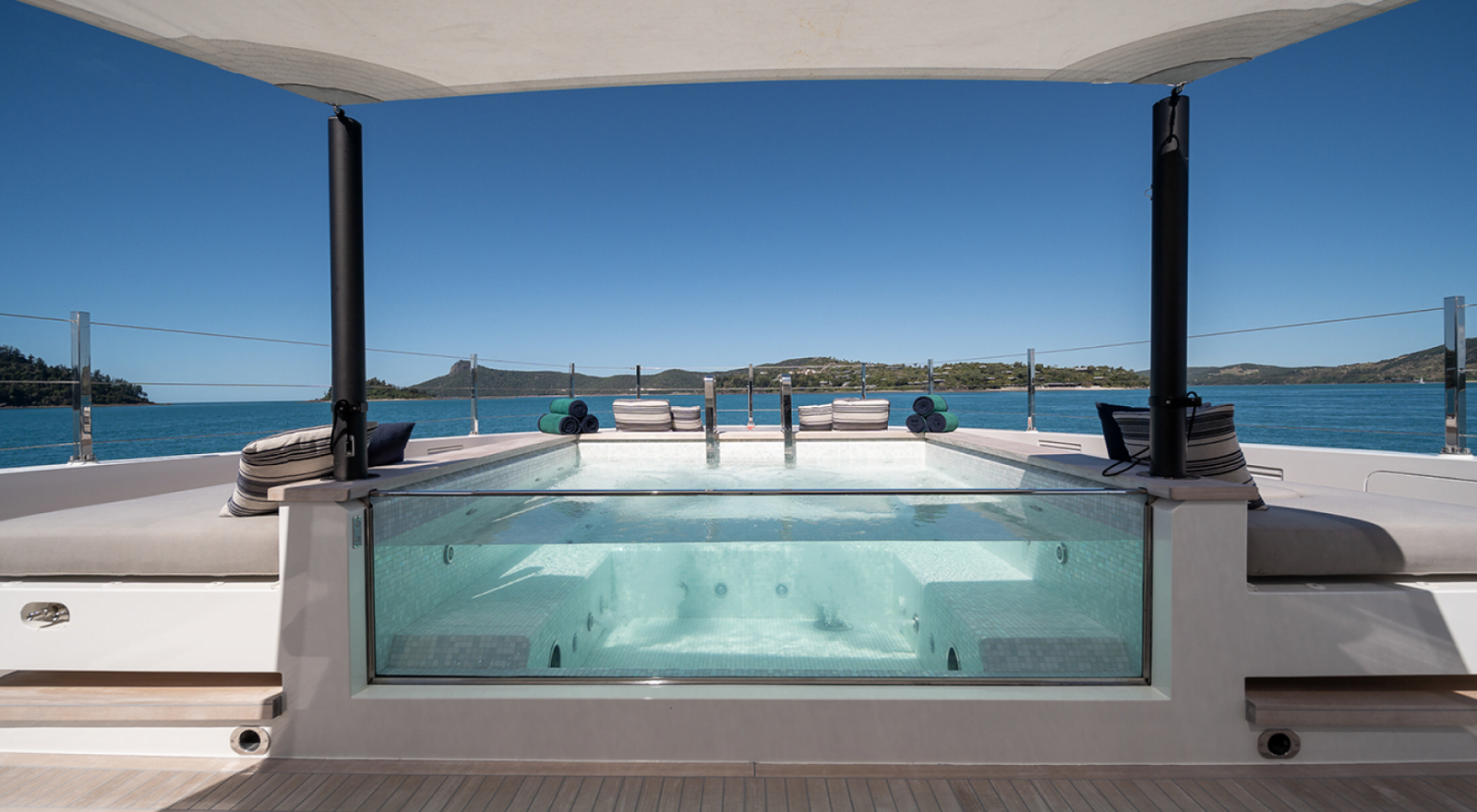 The deck pool set against the harbour shoreline