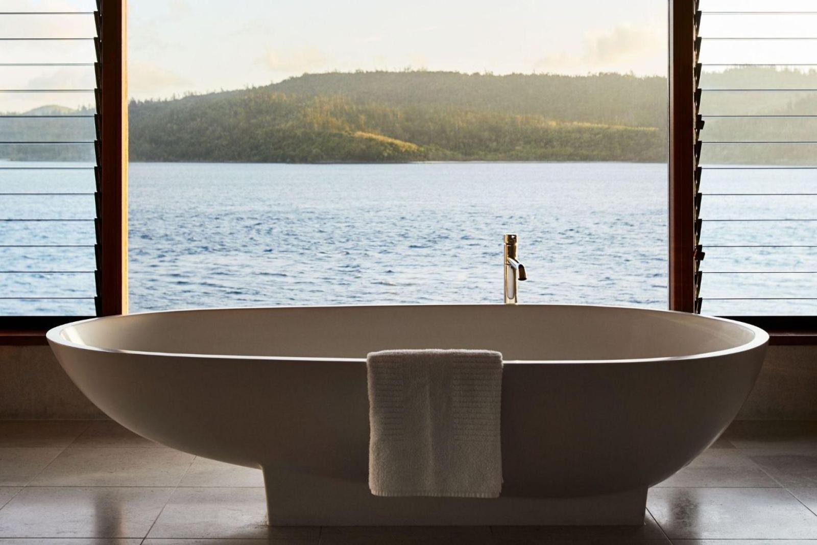 A Windward Pavilion bath, set against the sea