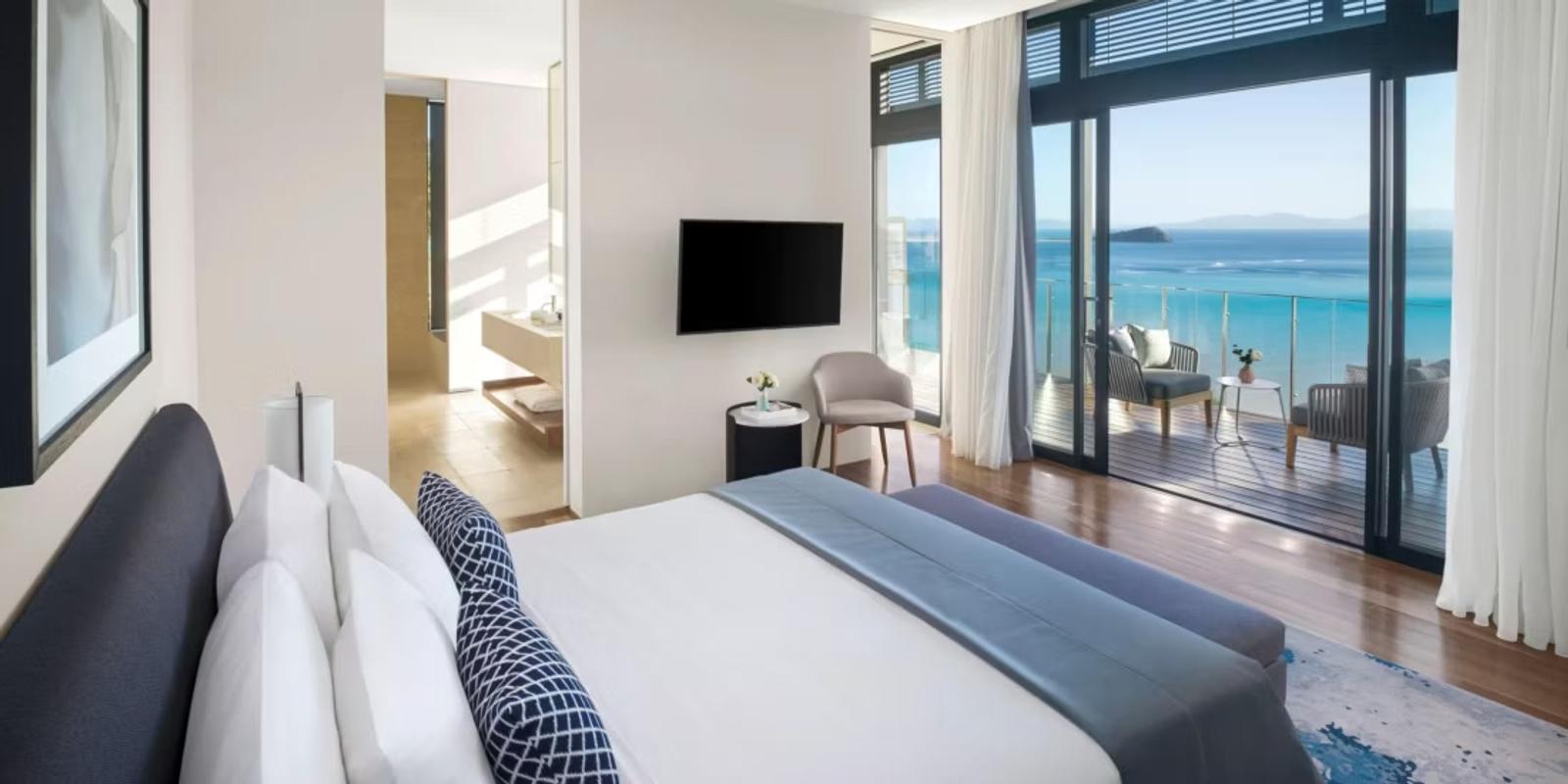 Suite bedroom opening to a sea-view balcony