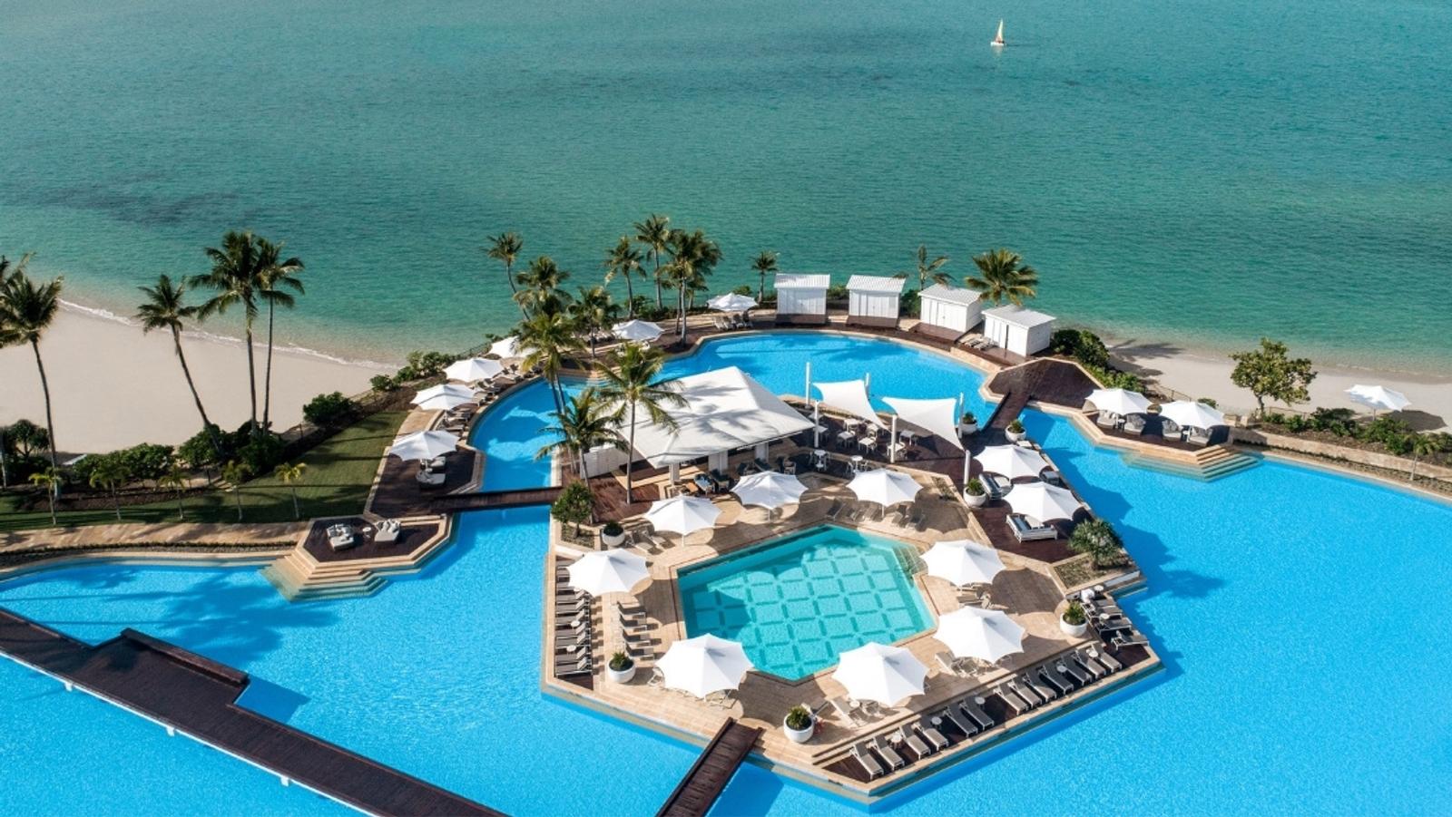 InterContinental Hayman Island from the air — the Pool Wing wrapping Hayman Pool, beach beyond