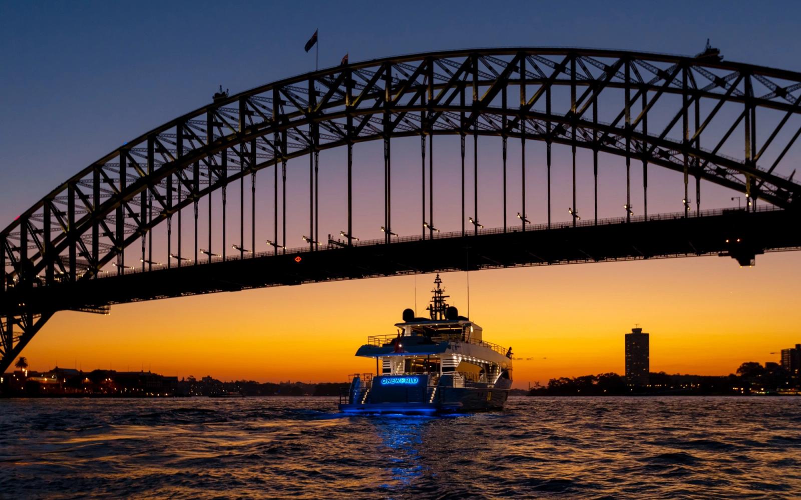 ONEWORLD beneath the Harbour Bridge at sunset