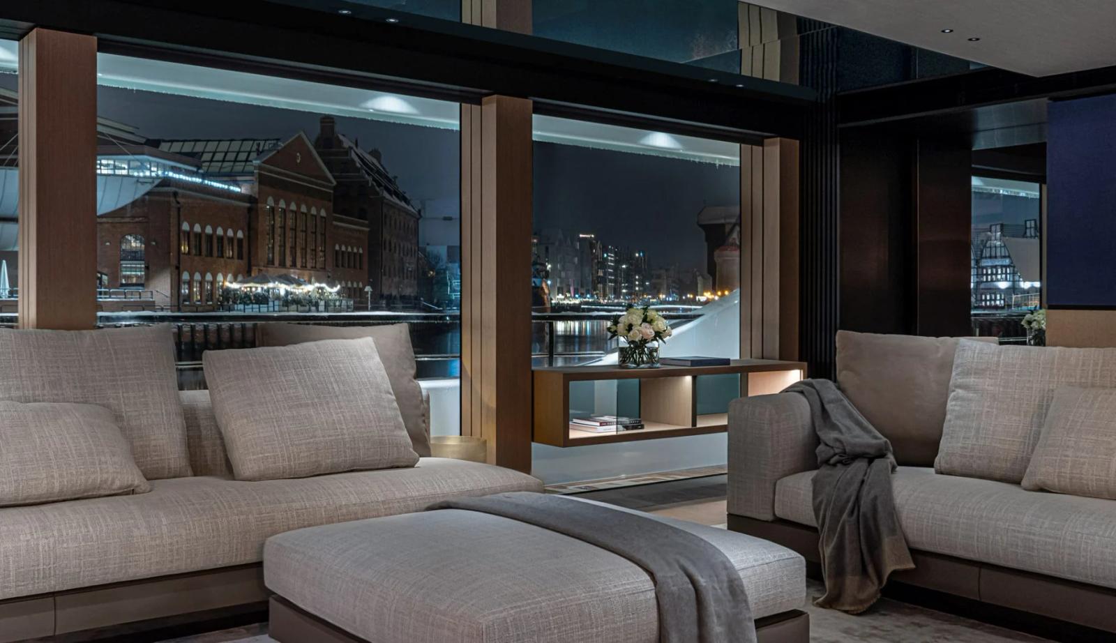 Ace — main salon night quayside view