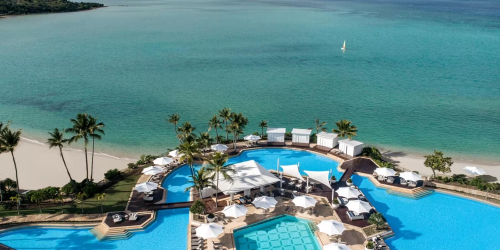 InterContinental Hayman Island from the air — pools, palms and the Coral Sea