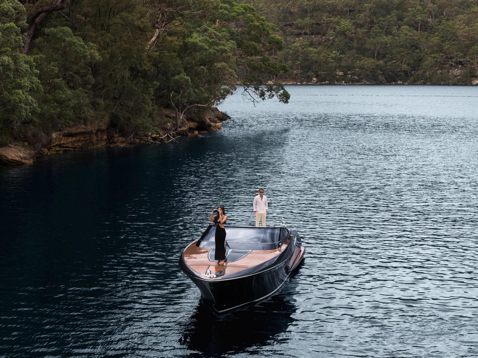 Guests aboard a day boat in a sheltered, hinterland-backed cove