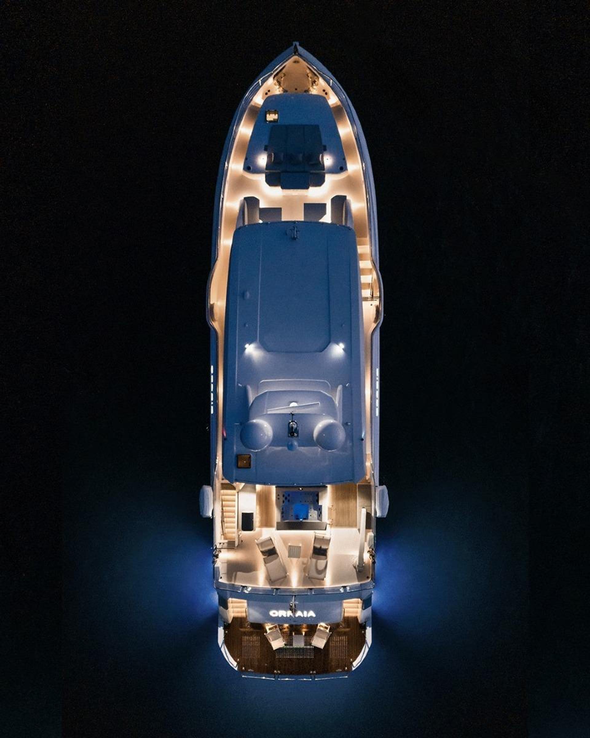 ORRAIA superyacht lit up from above at night, moored dockside