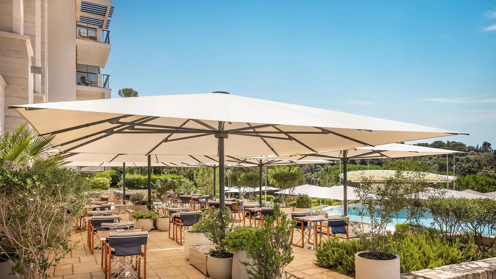 The pool terrace under its parasols