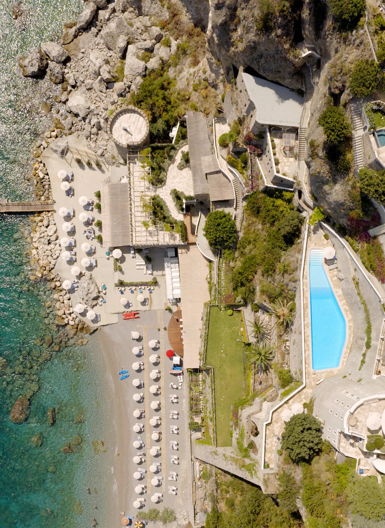 The beach club, pools and jetty at Borgo Santandrea seen from above