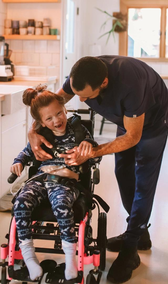 Carer helping disabled kid