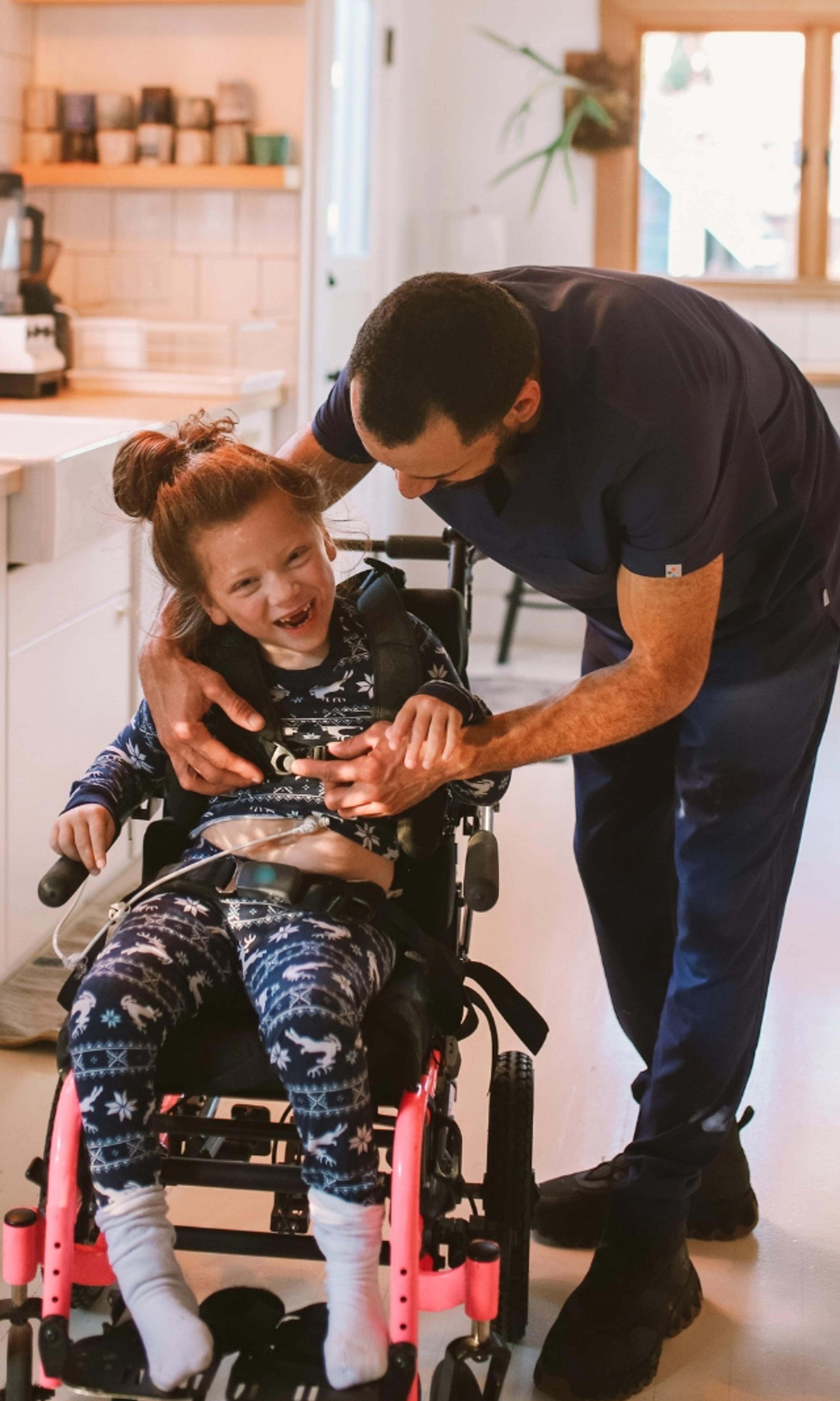 Carer helping disabled kid