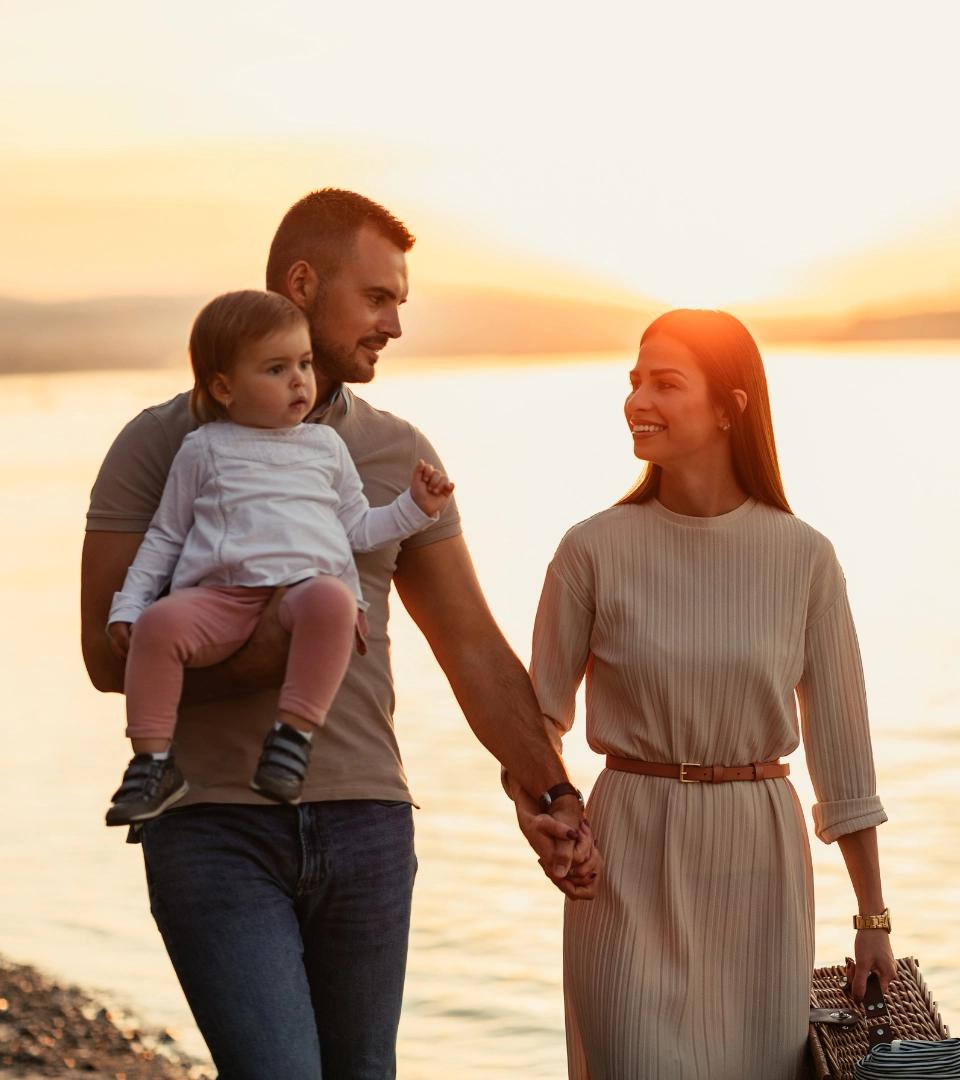 Couple with kid at sunset