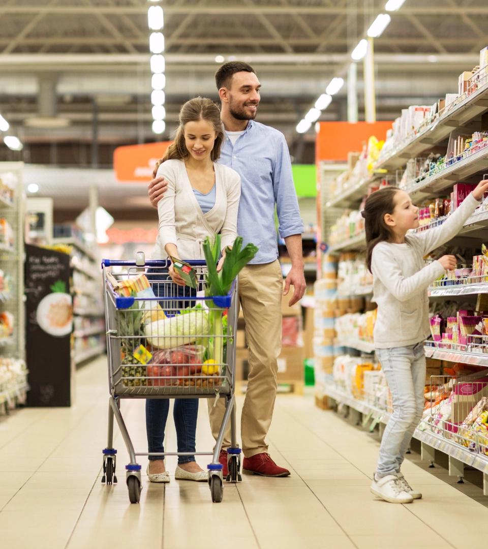 Couple with kidshopping with cart