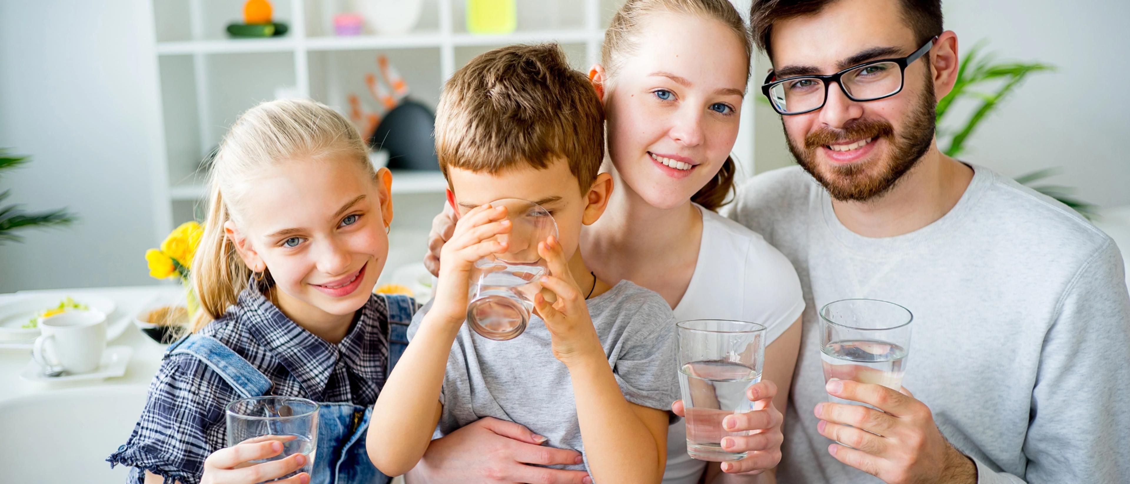 Family drinking clean filtered water from glass