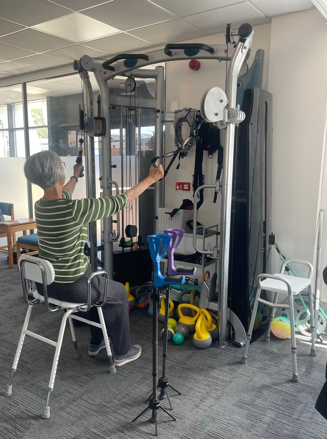 An adult working through an exercise using specialist gym equipment