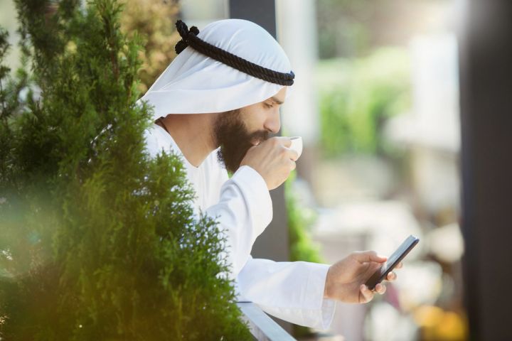 Muslim man banking on mobile 
