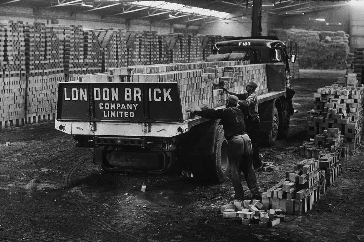B&W photo of workers loading up London Brick Company truck