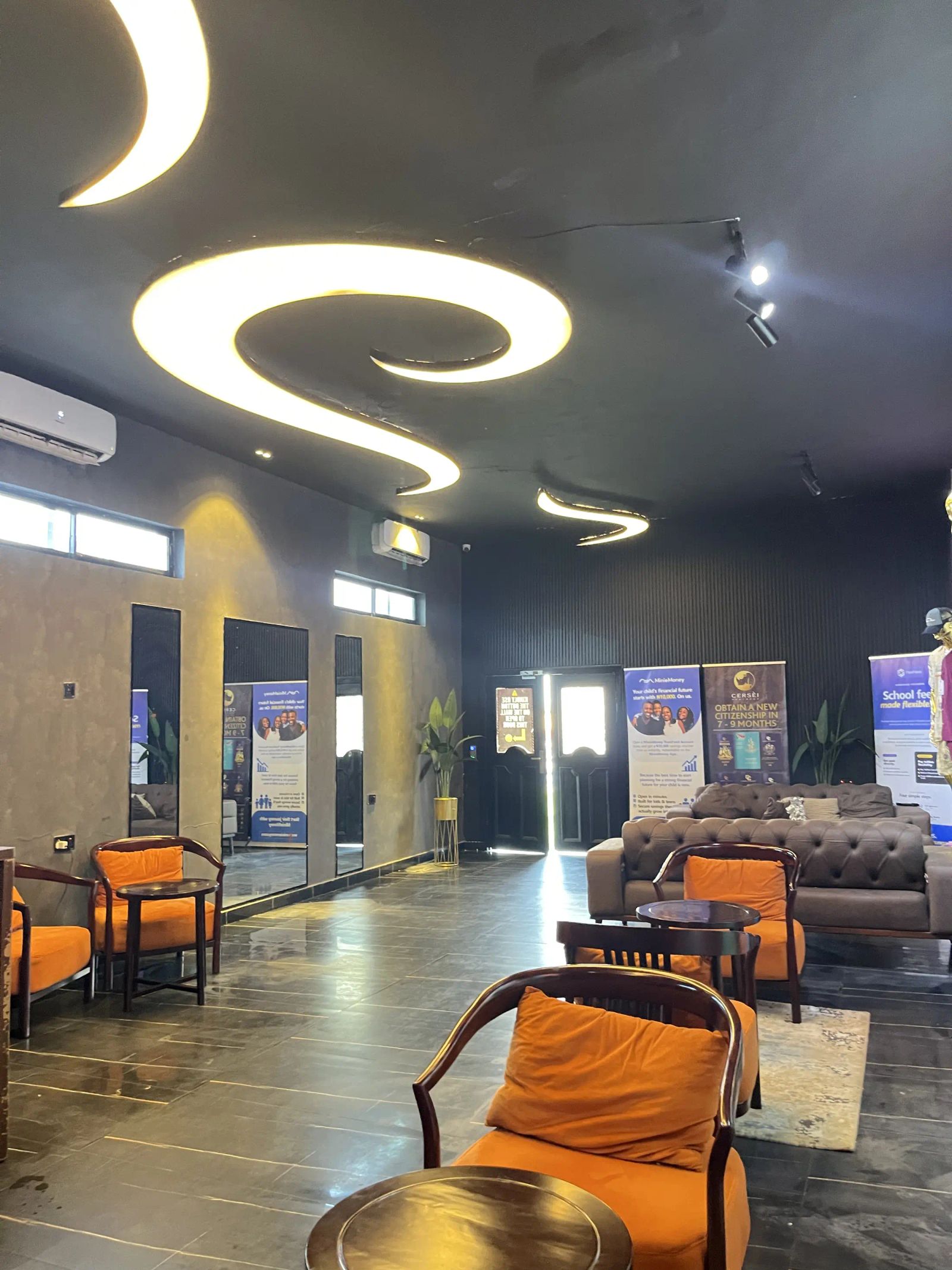 The lounge inside, orange chairs and a curved light