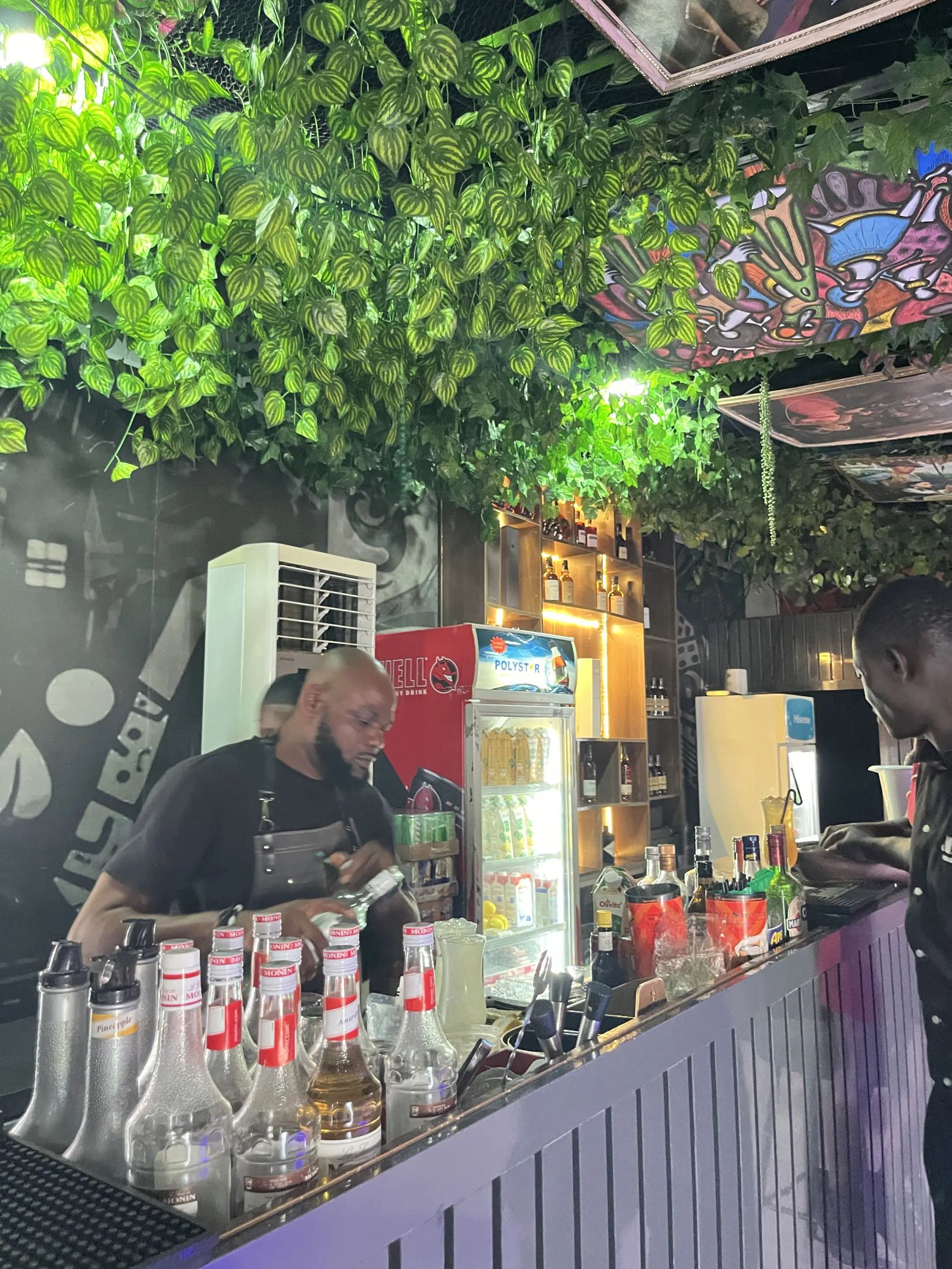 A bartender mixing drinks at the bar