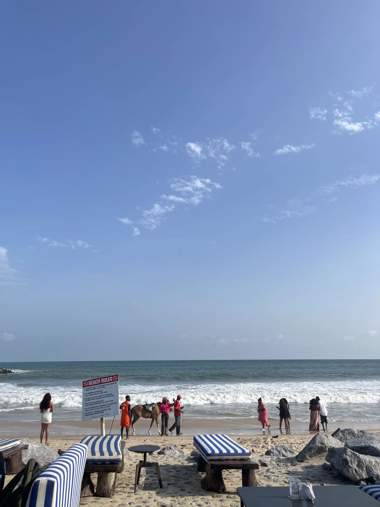 People on the beach at the edge of the sea