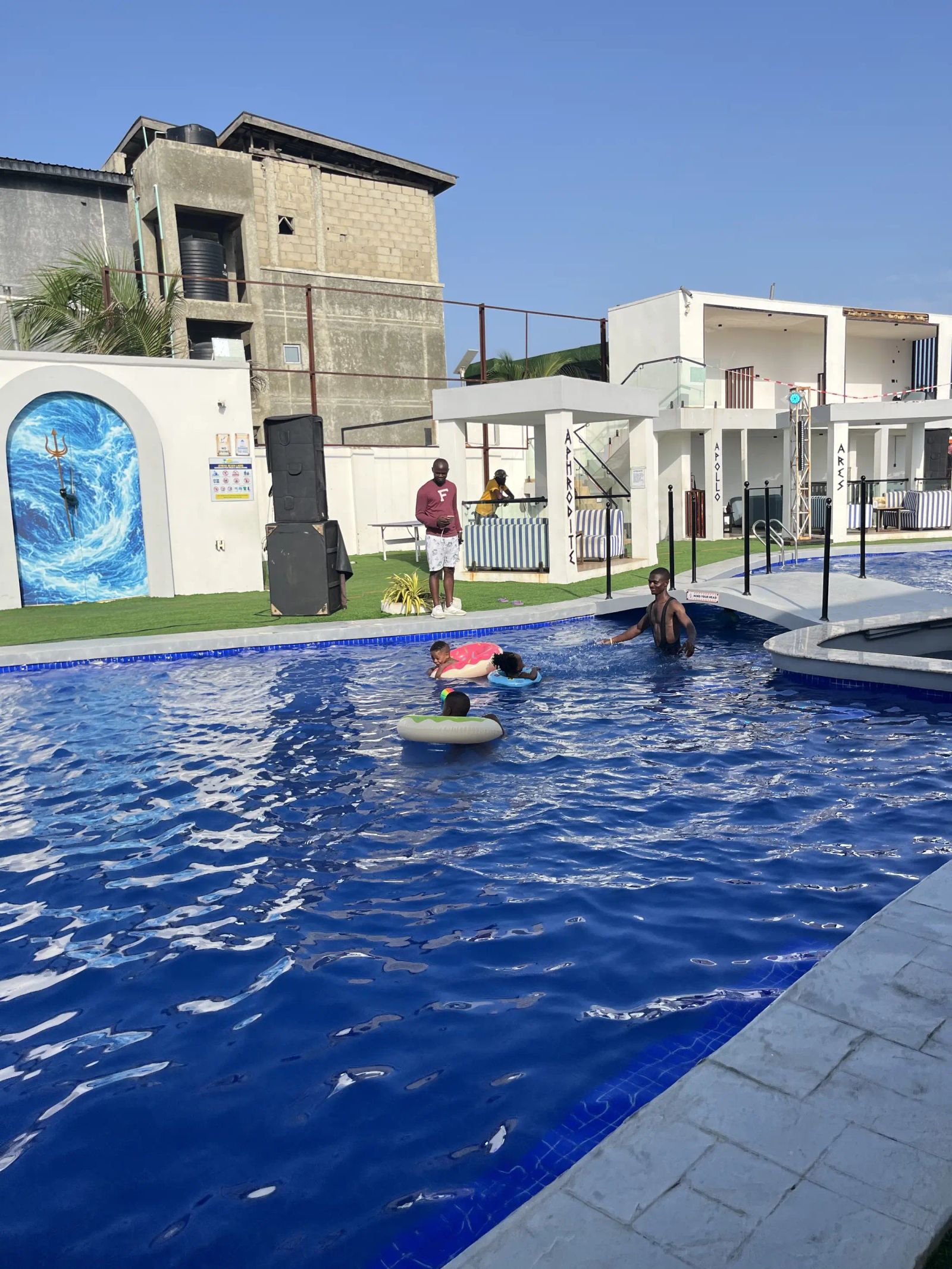 A guest on a float in the pool beside the painted arch