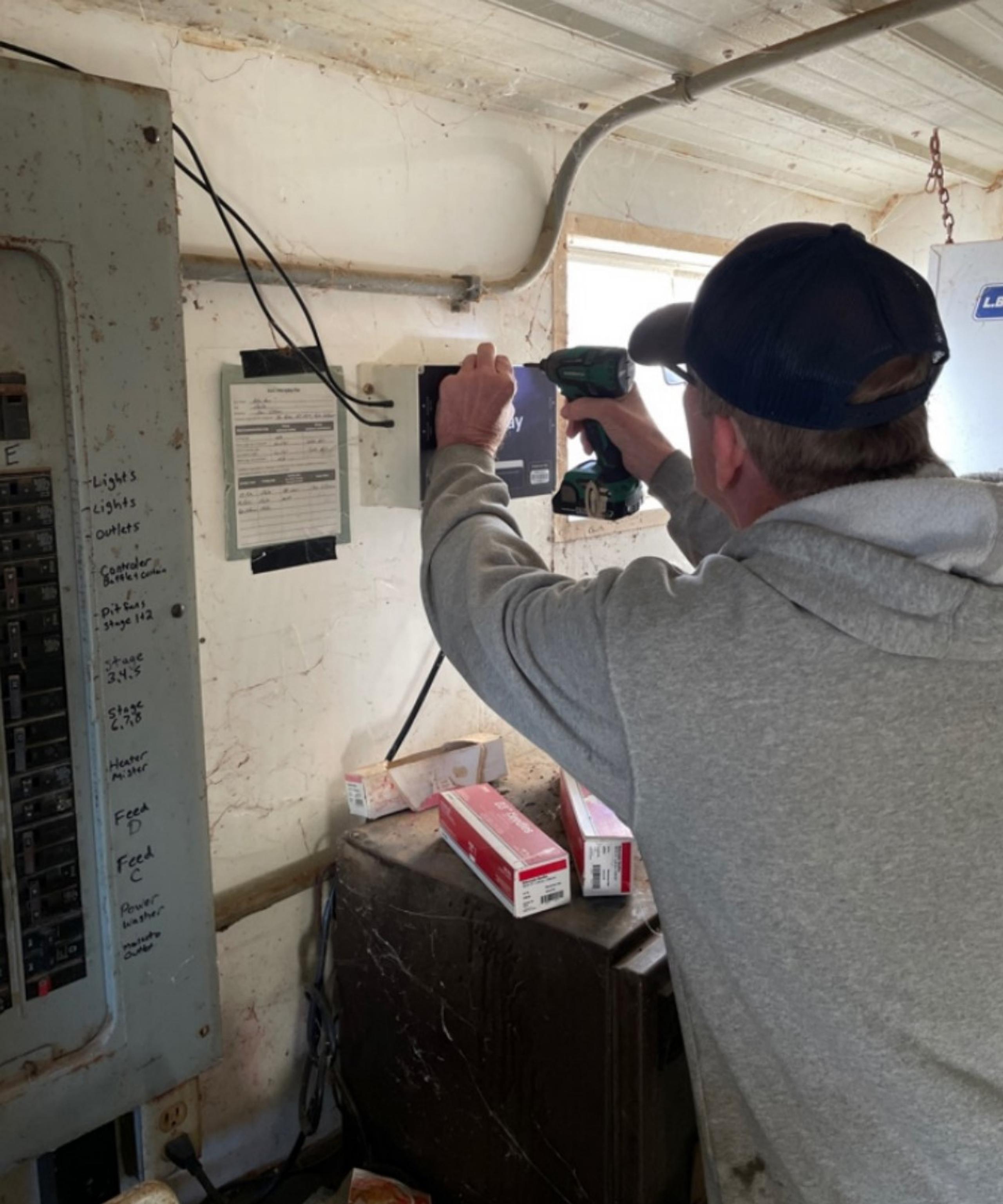 Jon Ryken installing barn alarm