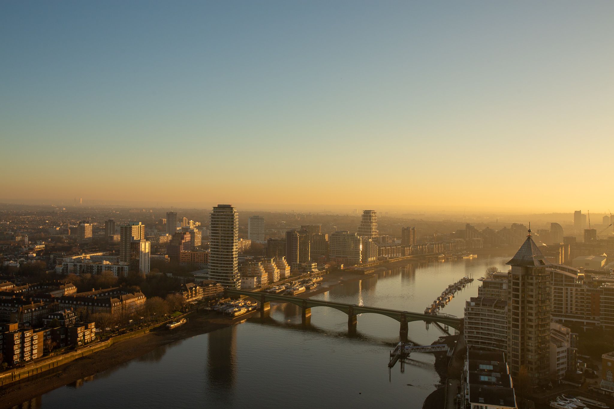Panoramic Sunrise View of London Skyline with Modern Architecture and Golden Hour Lighting Panoramic sunrise view of London skyline with river, bridges, and modern high-rise buildings