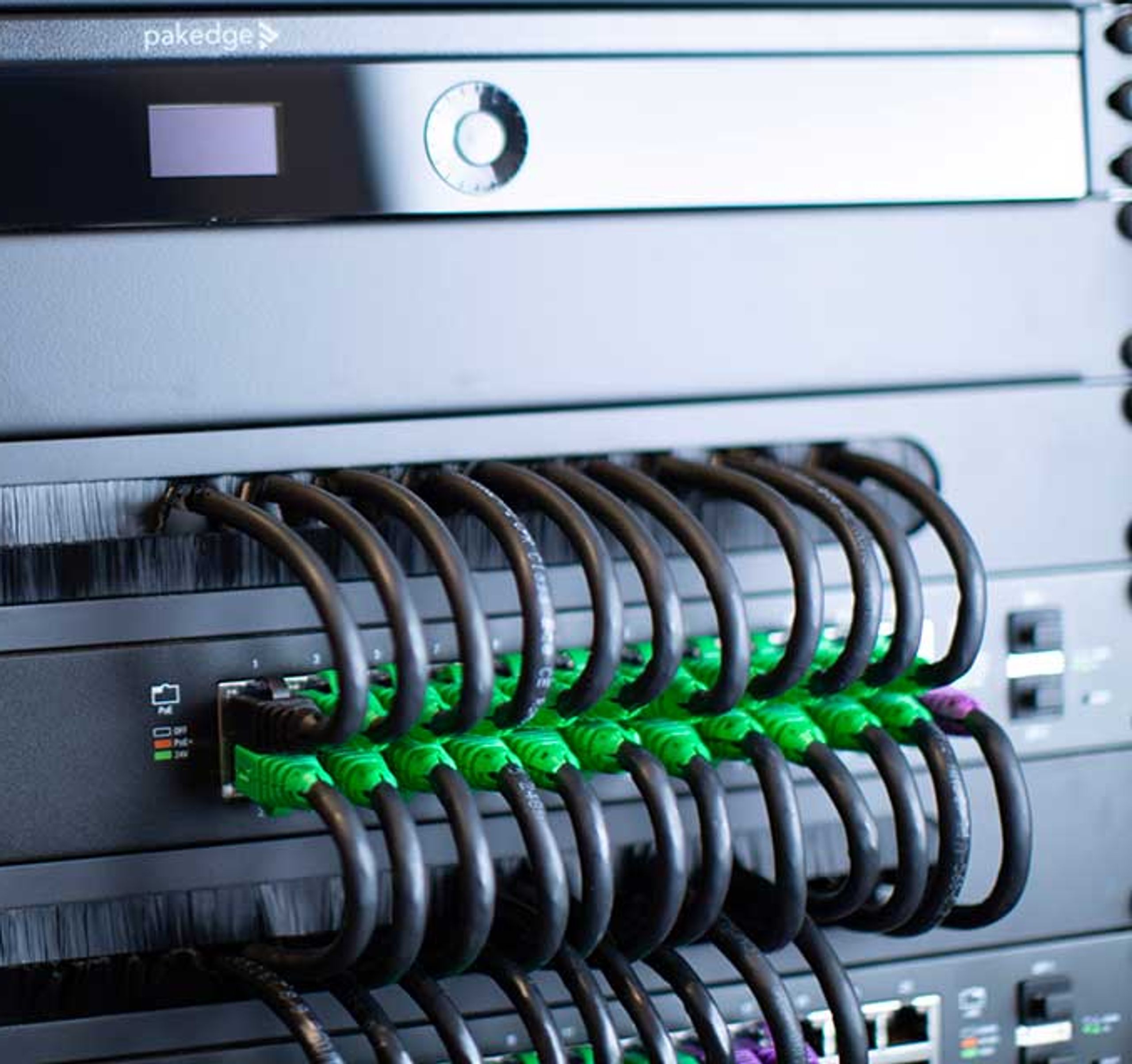 Smart Home Maintenance and Support Plans - Keep Your Control System Running Smoothly Professional technician performing software and firmware updates on smart home control system equipment rack during maintenance service visit