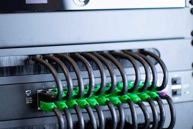 Smart Home Maintenance and Support Plans - Keep Your Control System Running Smoothly Professional technician performing software and firmware updates on smart home control system equipment rack during maintenance service visit