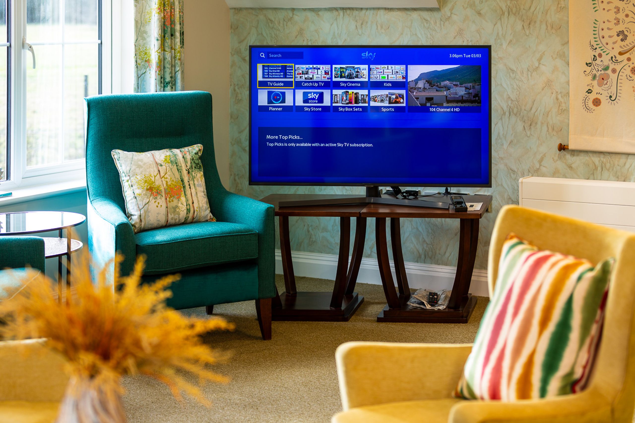 Care home lounge with television and seating