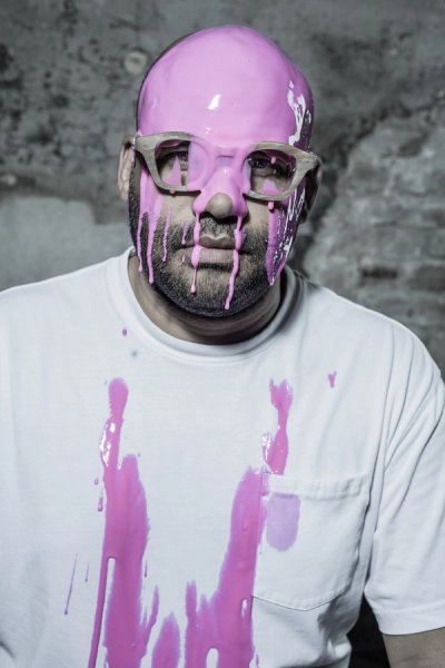 portrait of model getting paint on his face