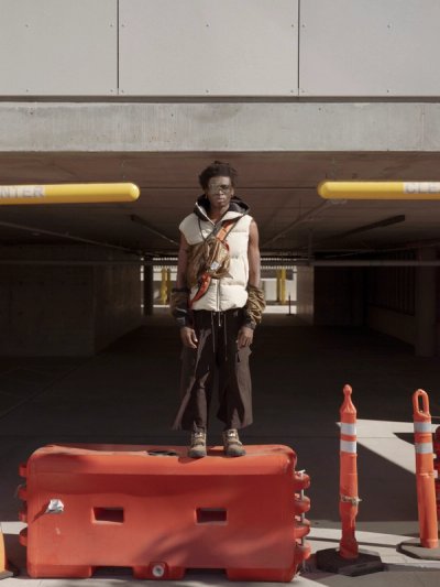 model standing on street furniture