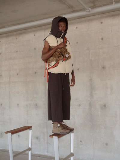 black model standing on structure