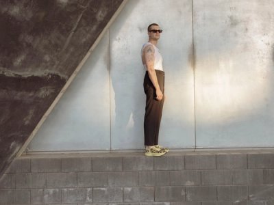 male model standing on brutalist structure