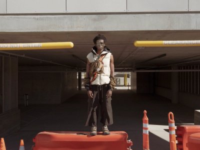 black model on construction barrier