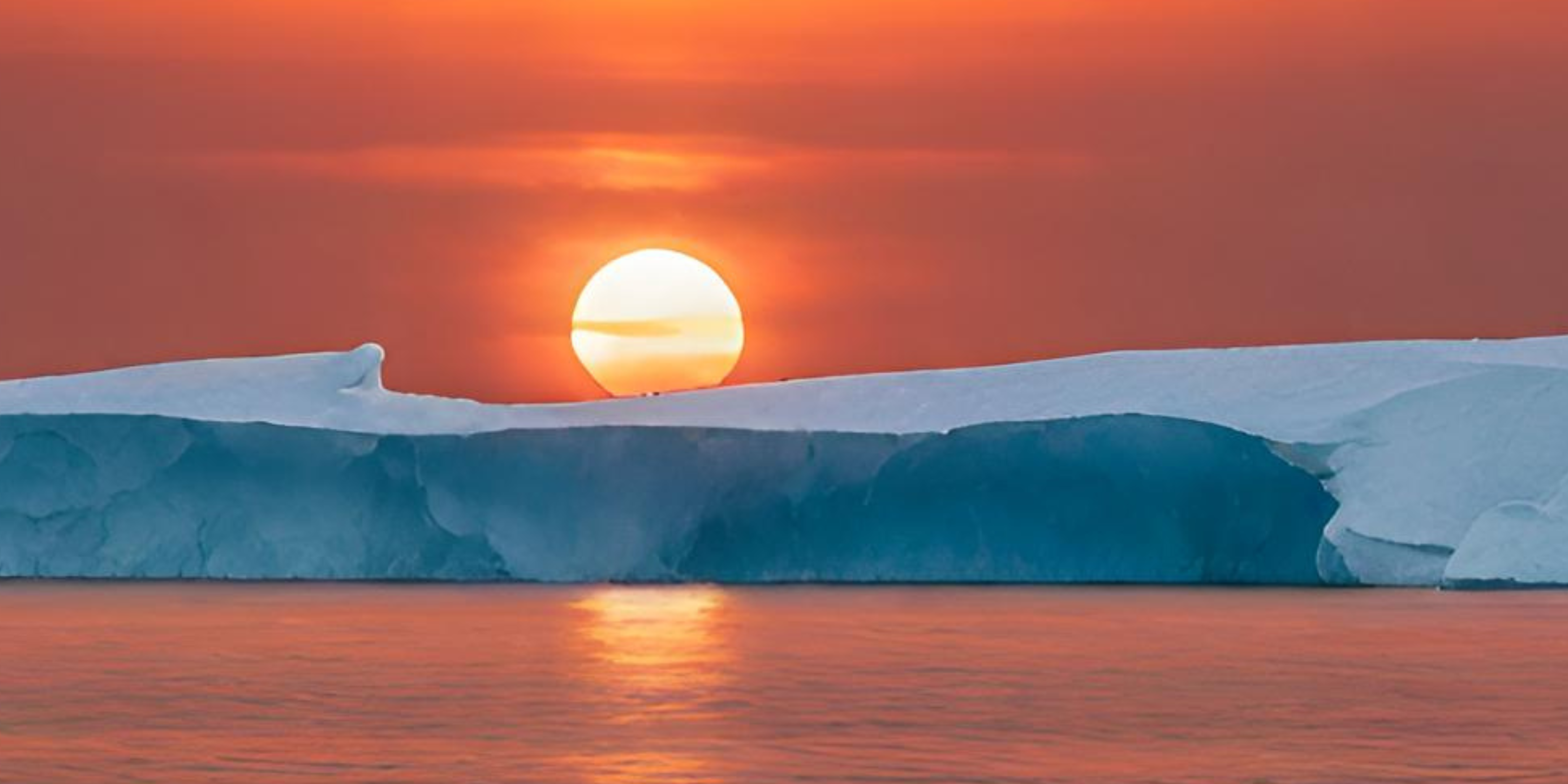 Iceberg in an orange sunset